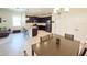 Open-concept kitchen with dark cabinets and granite counters flows into the dining area and living space at 1021 Golden Dawn Loop, Minneola, FL 34715