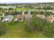 Picturesque neighborhood aerial view featuring a lake, homes, and lush green landscapes at 114 Harwood Cir, Kissimmee, FL 34744