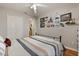 Bedroom with a striped bedspread, closet doors, and walls decorated with Disney-themed artwork at 114 Harwood Cir, Kissimmee, FL 34744