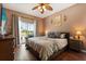 Comfortable bedroom with a view of the pool area, hardwood floors, and neutral tones at 114 Harwood Cir, Kissimmee, FL 34744