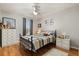 Bright bedroom with a decorative bed, a ceiling fan, a dresser, and Disney-themed decor at 114 Harwood Cir, Kissimmee, FL 34744