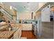 A functional kitchen showcasing stainless steel appliances, granite countertops, and a staircase in the background at 114 Harwood Cir, Kissimmee, FL 34744