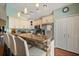 Well-lit kitchen featuring white cabinets, granite countertops, stainless steel appliances, and a breakfast bar at 114 Harwood Cir, Kissimmee, FL 34744