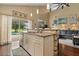 Open kitchen with granite countertops, stainless steel appliances, and a view to the backyard pool at 114 Harwood Cir, Kissimmee, FL 34744