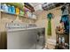 Functional laundry room featuring modern washer and dryer units and ample shelving for storage at 114 Harwood Cir, Kissimmee, FL 34744