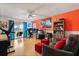 Bright living space with a desk, gaming equipment, and sliding glass doors with a patio view at 114 Harwood Cir, Kissimmee, FL 34744