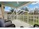 Relaxing screened-in patio with white wood flooring and views of lush greenery at 114 Harwood Cir, Kissimmee, FL 34744