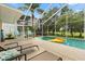 Enclosed pool area with lounge chairs, outdoor dining set, and a clear view of the backyard at 114 Harwood Cir, Kissimmee, FL 34744