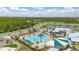 Aerial view of community pool and playground in lush, green surroundings at 11844 Founders St, Orlando, FL 32832