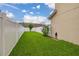Side yard with lush green lawn and a privacy fence at 11844 Founders St, Orlando, FL 32832