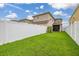 Spacious backyard featuring a white vinyl fence and healthy green grass at 11844 Founders St, Orlando, FL 32832