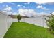 Lush green backyard featuring a white privacy fence at 11844 Founders St, Orlando, FL 32832
