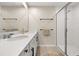 Bright bathroom showcasing double sinks, modern fixtures, a glass-enclosed shower, and tile flooring at 11844 Founders St, Orlando, FL 32832