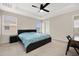 Carpeted bedroom featuring neutral decor, a ceiling fan, and a large window at 11844 Founders St, Orlando, FL 32832