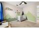 Stylized bedroom with playful mountain wall design and themed ceiling fan at 11844 Founders St, Orlando, FL 32832