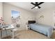 Bedroom with a ceiling fan, window for natural light, and comfortable decor at 11844 Founders St, Orlando, FL 32832