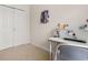 Bright bedroom featuring a closet, and a desk with pegboard for creative design at 11844 Founders St, Orlando, FL 32832