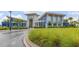 Modern community clubhouse with distinctive blue and white architecture and lush landscaping at 11844 Founders St, Orlando, FL 32832