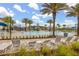 Community pool area featuring palm trees, lounge chairs, and a colorful ' water slide at 11844 Founders St, Orlando, FL 32832
