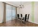 Dining room with glass table, modern chairs, decorative curtains, and chandelier at 11844 Founders St, Orlando, FL 32832