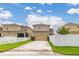 Street view of home showcasing driveway and attractive landscaping at 11844 Founders St, Orlando, FL 32832