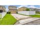 Exterior view of home with a driveway and a white privacy fence at 11844 Founders St, Orlando, FL 32832