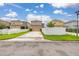 Street view of homes with driveways and tidy landscaping at 11844 Founders St, Orlando, FL 32832
