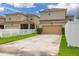Exterior view of home showing the driveway and white vinyl fence at 11844 Founders St, Orlando, FL 32832