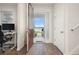 Welcoming foyer with wood-look tile floors and staircase, bright natural lighting and adjacent office space at 11844 Founders St, Orlando, FL 32832