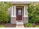 Close-up of front entrance with columns, walkway, lighting and decorative shrubs at 11844 Founders St, Orlando, FL 32832