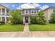 Charming two-story home with green lawn, landscaped shrubs, and light tan exterior paint at 11844 Founders St, Orlando, FL 32832