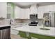 Kitchen featuring stainless appliances, white cabinets, large island, and wood-look floors at 11844 Founders St, Orlando, FL 32832