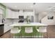 Bright, spacious kitchen with white cabinetry, stainless appliances, and modern island with seating at 11844 Founders St, Orlando, FL 32832