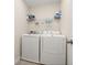 Functional laundry room with washer, dryer, and storage shelf at 11844 Founders St, Orlando, FL 32832
