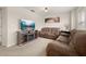 Upstairs living room with neutral carpet, comfortable sofas, and a modern TV stand at 11844 Founders St, Orlando, FL 32832