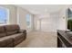 Upstairs living area with neutral carpet, a reclining couch, and lots of light at 11844 Founders St, Orlando, FL 32832