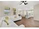 Open-concept living room featuring wood floors, white sofa, and view into the kitchen at 11844 Founders St, Orlando, FL 32832