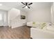 Bright living room featuring wood-look tile floors and a modern, white couch at 11844 Founders St, Orlando, FL 32832