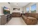 Upstairs living room with neutral carpet, comfortable sofas, and a modern TV stand at 11844 Founders St, Orlando, FL 32832