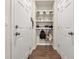 A well-organized mudroom featuring wood-look flooring, storage hooks and shelving at 11844 Founders St, Orlando, FL 32832
