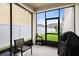 Enclosed patio space with seating area, grill, and access to a well-maintained backyard at 11844 Founders St, Orlando, FL 32832