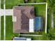 Aerial view of the home showing the roof, backyard, screened pool, and surrounding landscape at 12542 Idaho Woods Ln, Orlando, FL 32824