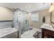 Bright bathroom features a glass enclosed shower, soaking tub and double sink vanity at 12542 Idaho Woods Ln, Orlando, FL 32824