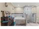Bathroom featuring a large soaking tub and glass enclosed shower, and vanity with ample storage at 12542 Idaho Woods Ln, Orlando, FL 32824
