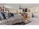 Spacious bedroom features an ornate four poster bed and view into ensuite bathroom at 12542 Idaho Woods Ln, Orlando, FL 32824