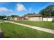 Charming single-story home with a two-car garage, lush lawn and well-maintained landscaping at 12542 Idaho Woods Ln, Orlando, FL 32824