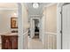 Hallway leading to bedrooms and bathroom with paneled walls and recessed lighting at 12542 Idaho Woods Ln, Orlando, FL 32824