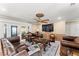 Comfortable living room featuring a ceiling fan, plush furniture, and access to the screened porch at 12542 Idaho Woods Ln, Orlando, FL 32824