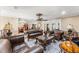 Spacious living room with leather furniture, ornate details, ceiling fan, and decorative rug creating an elegant atmosphere at 12542 Idaho Woods Ln, Orlando, FL 32824