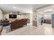 Open-concept living room flowing into the kitchen, complete with tiled floors and comfortable seating at 12542 Idaho Woods Ln, Orlando, FL 32824
